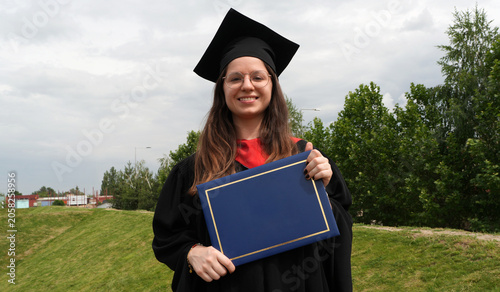 young female graduate holding diploma