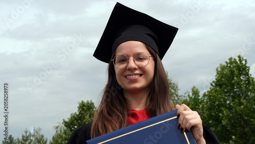 close up portrait of a young female with diploma 