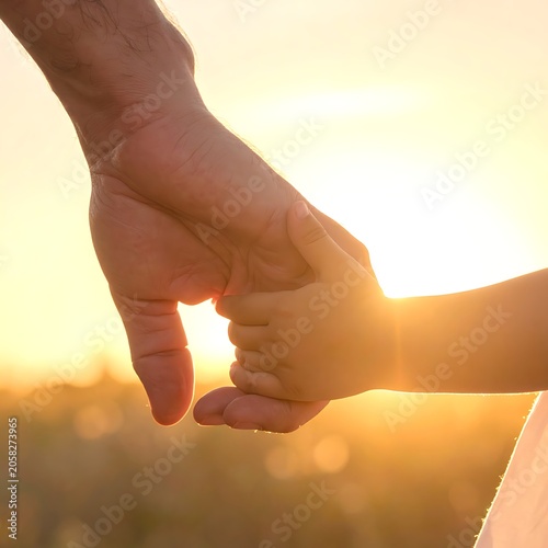 Holding hands at sunset