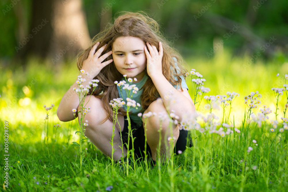 Fototapeta premium Dreamy sunlight creates warm childhood mood. Soft dreamy bokeh surrounds cute girl. Dreamy meadow scene feels relaxing. Dreamy portrait highlights positive emotion.