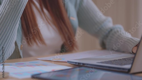 Close up of businessman hands typing on laptop keyboard at desk in minimal workspace. professional working on computer, entering text, managing information during daily business tasks at workplace.