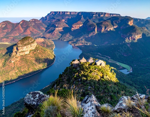 A serene landscape of a winding river through a rugged, mountainous valley