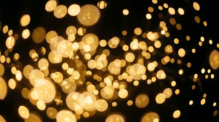 Sparkling golden fairy lights glowing warmly in dark bokeh background