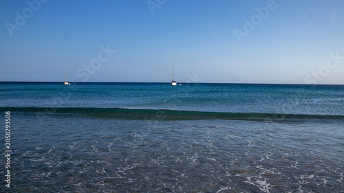 Two Sailboats on Calm Blue Ocean Water with Gentle Waves