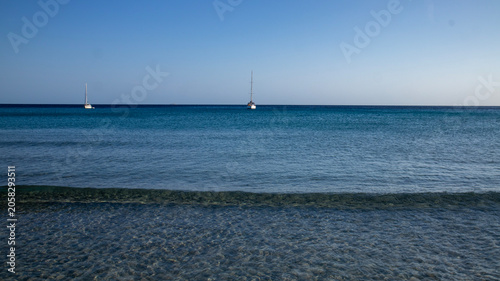 Two Sailboats on Calm Blue Ocean Water with Gentle Waves