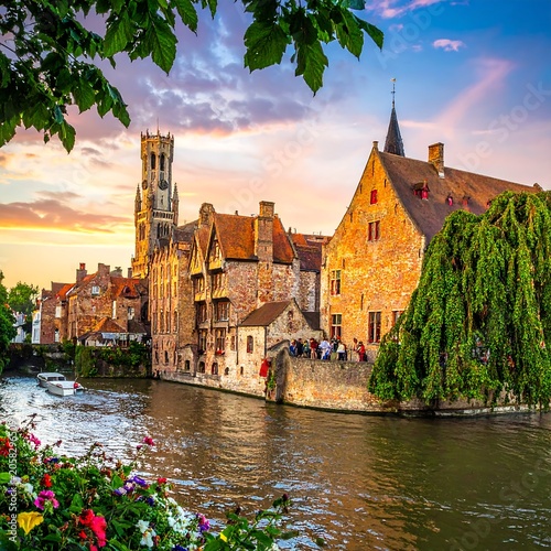 A serene medieval town along a tranquil canal at sunset