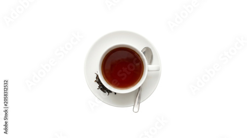 Top view of a cup of hot black tea with a spoon on a saucer.