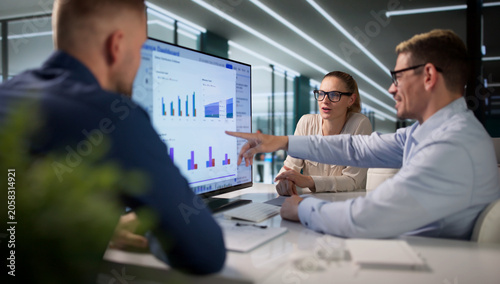 Diverse Team Reviews Risk Data Together While