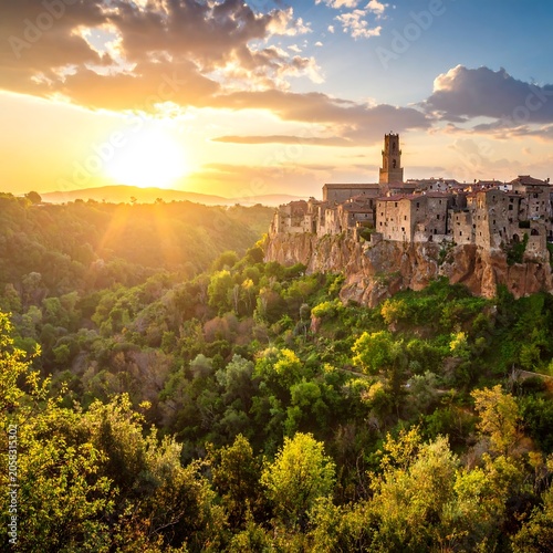 A serene sunset scene of an ancient hillside town surrounded by lush greenery