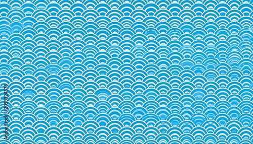 A vibrant blue pattern of wave-like shapes on a white background