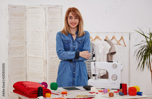 Fashion designer portrait in clothing workshop
