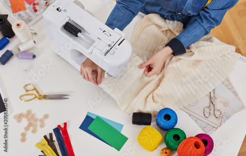 Overhead view of sewing machine and textile crafting workspace
