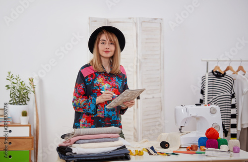 Fashion designer reviewing garment patterns in creative studio