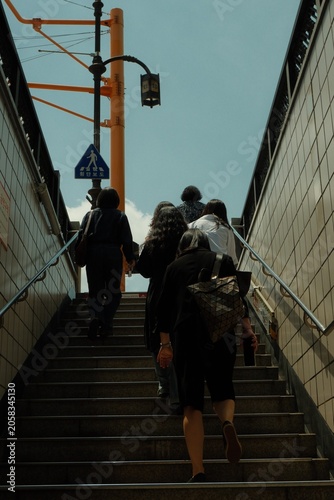 Photography People climbing stairs out of subway station exit into street in Seoul South Kor