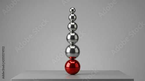 Stack of Balanced Metallic and Red Spheres on Grey Background