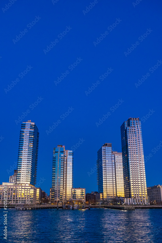 Obraz premium Modern Waterfront Skyscrapers in New York City at Blue Hour