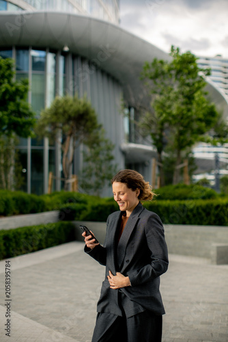 Woman uses smartphone in ur...