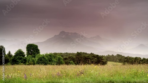 Summer meadow and rainy clouds over mountain Grande Tete de L'Obiou, Dauphine Prealps in south-western Alps, department of Isere in France Europe. Time lapse
