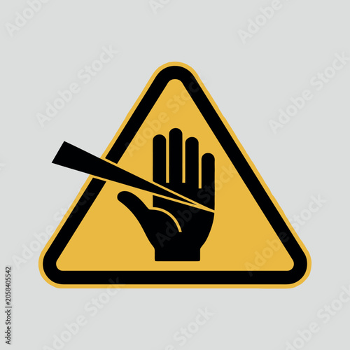 Warning sign indicating sharp object danger to hand