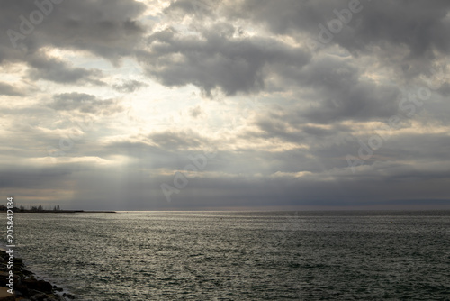 Dramatic Storm Clouds, Sunbeams, Sea Horizon and Coastal Waterscape