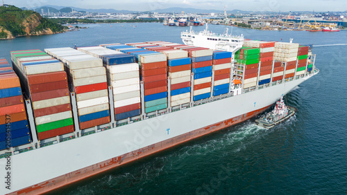 Quadro su tela stern cargo container ship shipping containers approaching a bustling commercial port, representing global maritime logistics, international trade, and import export