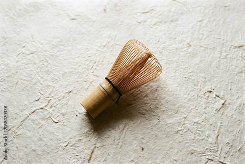 traditional japanese bamboo matcha whisk on textured handmade paper
