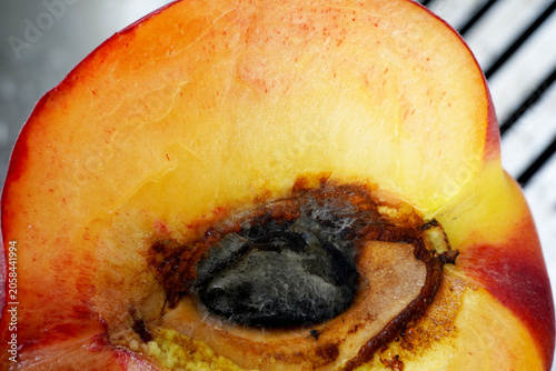 Close-up of a freshly cut peach half revealing its juicy flesh. Close-Up Fresh Peach Half. Juicy Fruit Macro Food Photography.