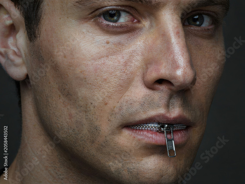Close up of a man's face with a metal zipper instead of a mouth, conceptual surrealism representing silence and censorship. Generative AI.