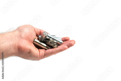 Konstfotografi Batteries in hand on white background, used batteries