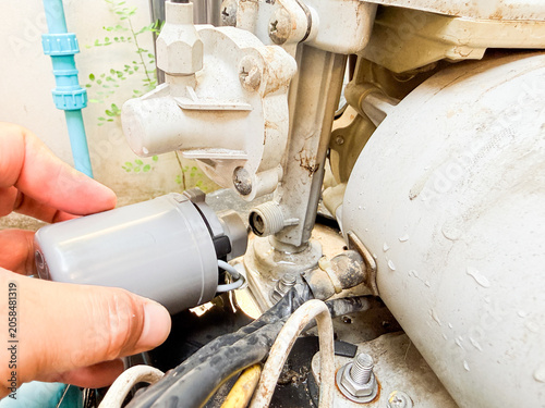 Realistic close-up of a pressure switch installed on an automatic water pump during maintenance. Ideal for plumbing, engineering, water systems, and technical service concepts.
