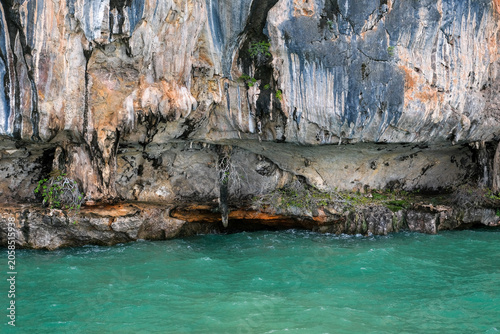 Limestone cliff and turquoise sea water in Phuket Thailand
