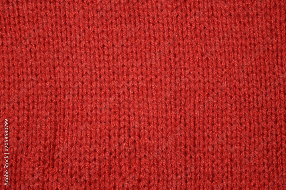 Fototapeta premium Close-up top view of red wool knitted texture background