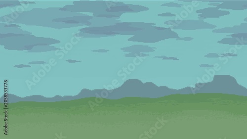 A natural landscape with inclement weather: cloudy skies, with grasslands in the foreground and mountains in the distance