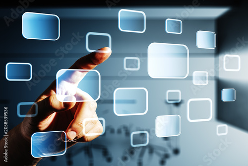 Close-up of a person touching floating digital interface buttons in an abstra...