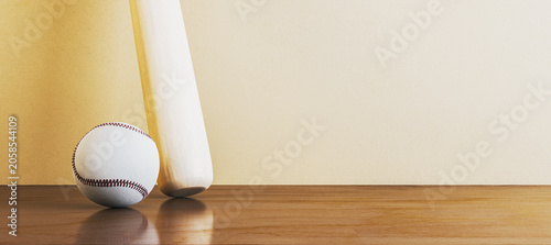 Baseball ball and wooden bat on a light wooden surface against an empty conte...