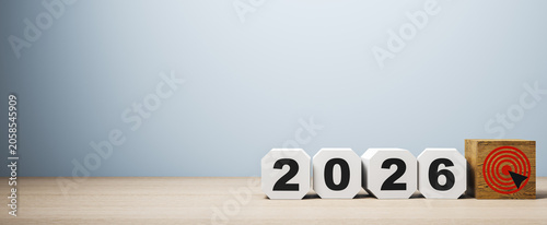 Fotografía 2026 cubes aligned with a wooden target block on a light blue background representing a goal concept for future direction and planning ahead