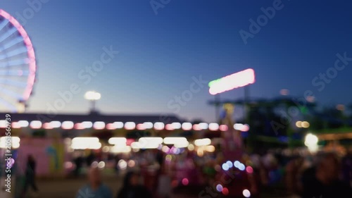 Blurred Carnival Lights With Colorful Bokeh At Amusement Park At Night