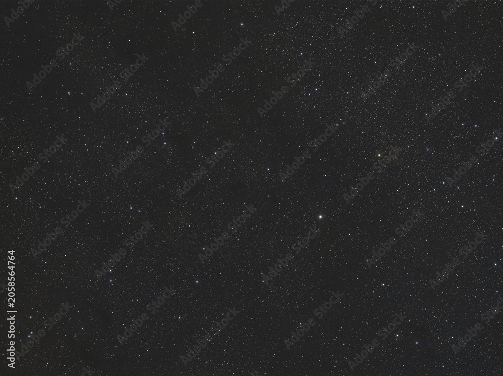 Fototapeta premium Vast dark night sky is visible, densely packed with myriad white and subtly colored stars. This cosmic view showcases celestial bodies in the depths of space at night.