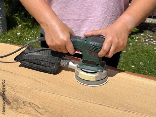 Artisan Finishing Wooden Surface in Workshop