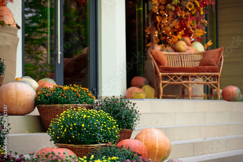 Autumn porch decor with pumpkins and mums creates a festive Thanksgiving scene
