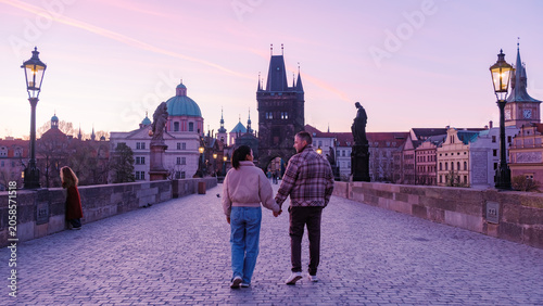 Photography Romantic sunset stroll on Charles Bridge in Prague by couples enjoying a perfect
