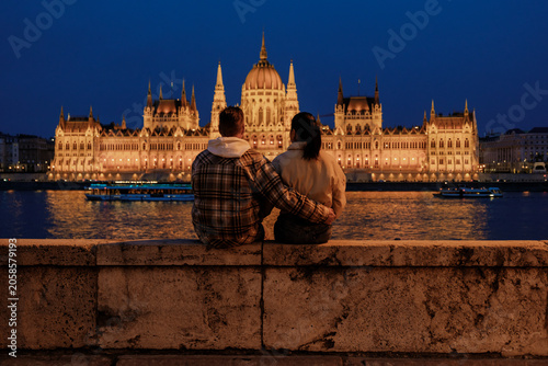 Couple enjoying a romantic evening by the Danube River in Budapest, Hungary at night