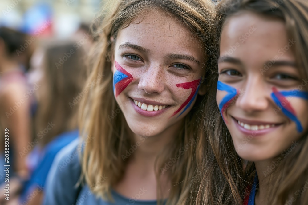 Fototapeta premium Smiling football supporters with abstract painted color shapes on cheeks