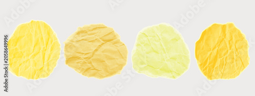 A crumpled pieces of yellow foil or paper. A round wrinkled round elements for a collage. Crushed material with jagged edges for scrapbooking. A gold scrap of a cut out sticker in a halftone vintage.