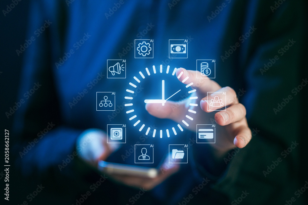 Fototapeta premium Hands interacting with digital time management icons while holding a smartphone in a modern setting during the evening