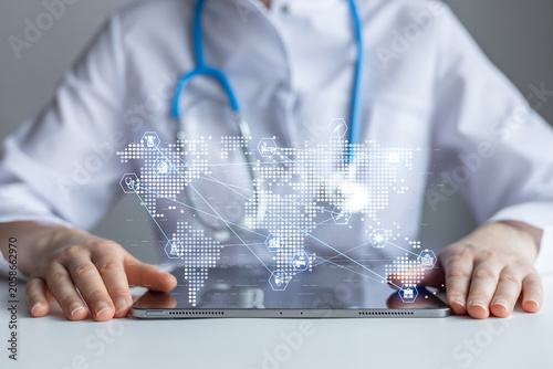 Health professional using tablet to access global medical data and information for patient care