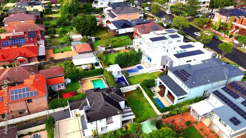 Drone panoramic aerial view of Sydney NSW Australia city Skyline and looking down on all suburban houses and streets of western Sydney of Burwood and Enfield
