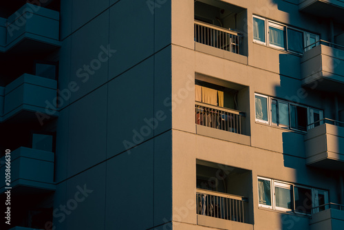 Foto Apartment building facade with balconies in warm shadow light