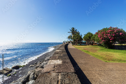 Coastal promenade and blue ocean under clear sky - Barachois in Reunion island