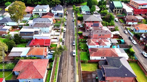 Drone panoramic aerial view of Sydney NSW Australia city Skyline and looking down on all suburban houses and streets of western Sydney of Burwood and Enfield
